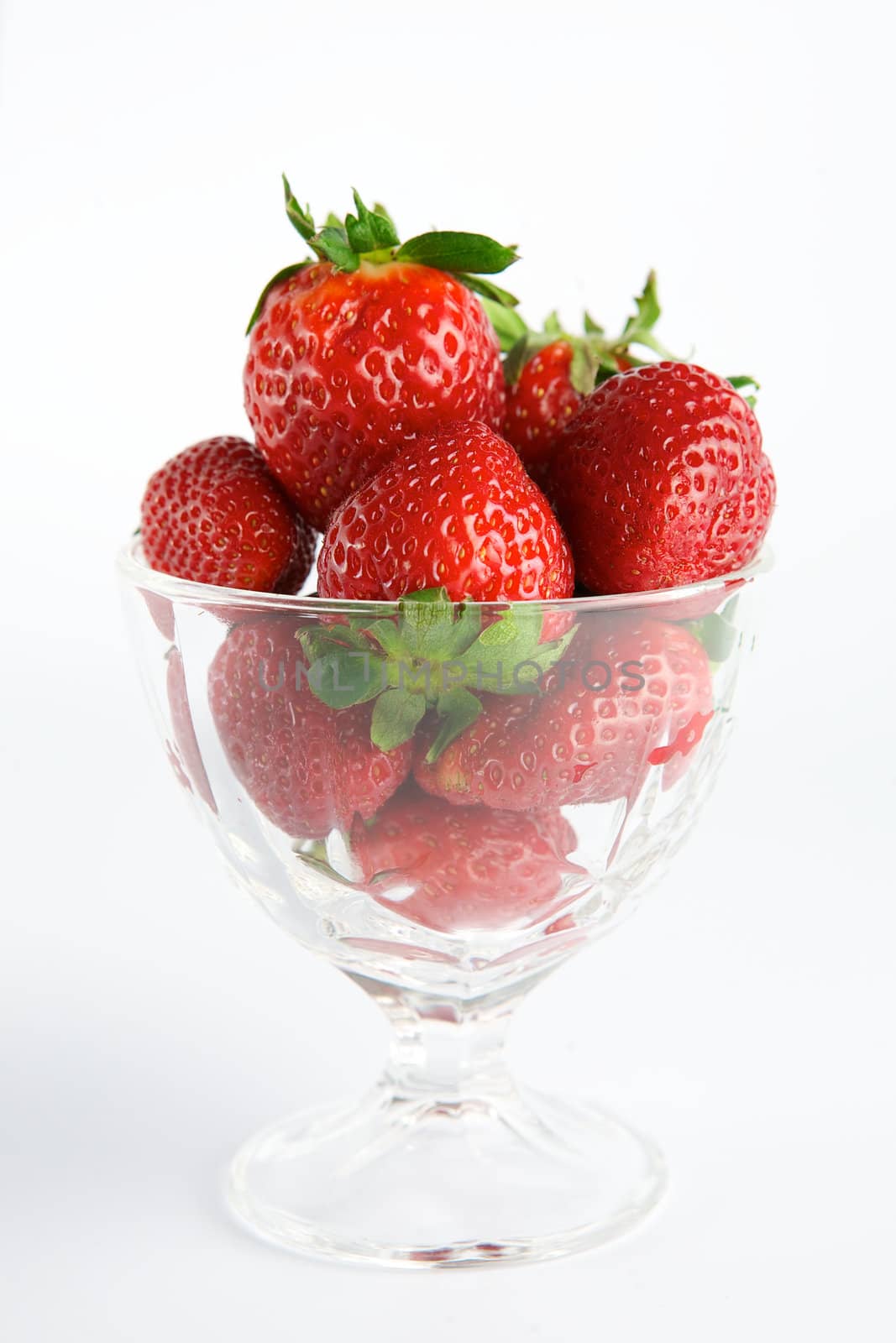 Strawberry in glass container on white background