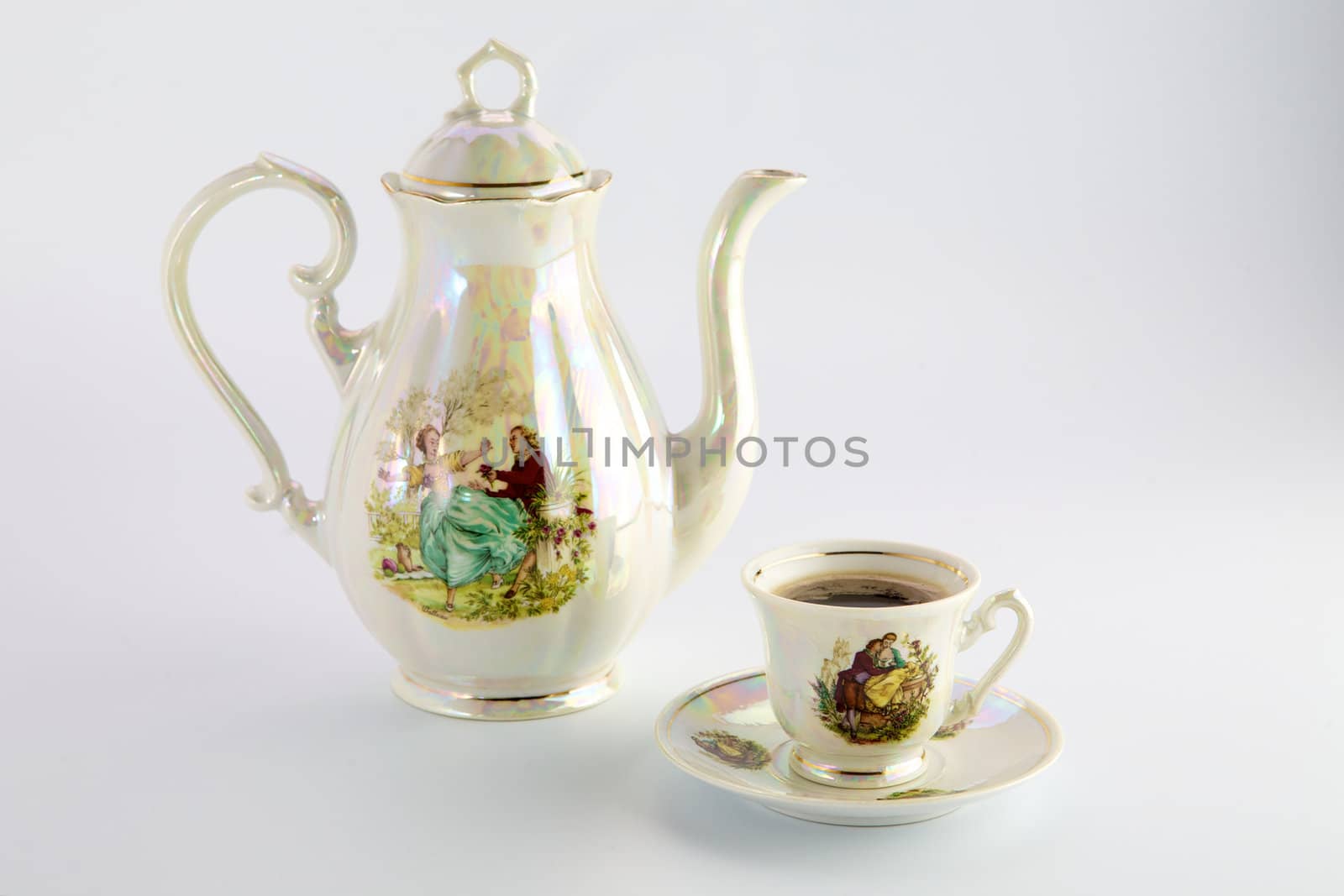 Beautiful old coffee pot and cup with a drawing