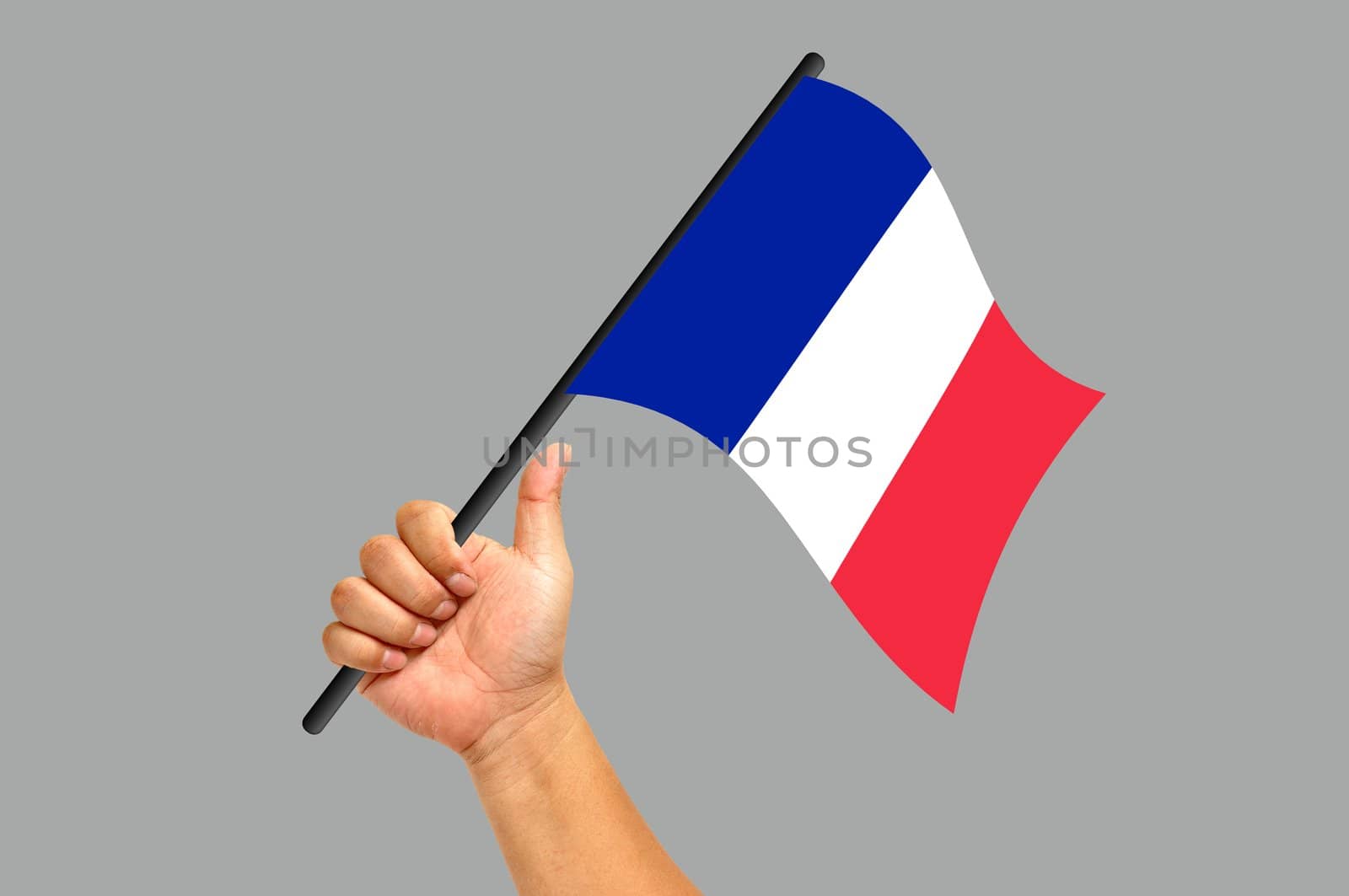 Hand holding France flag isolated on white background