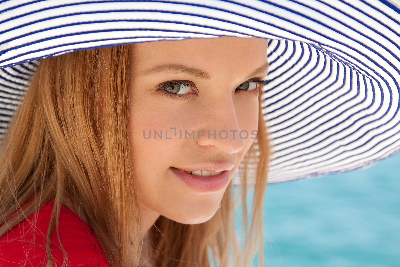 portrait of a beautiful young girl who rests on the coast