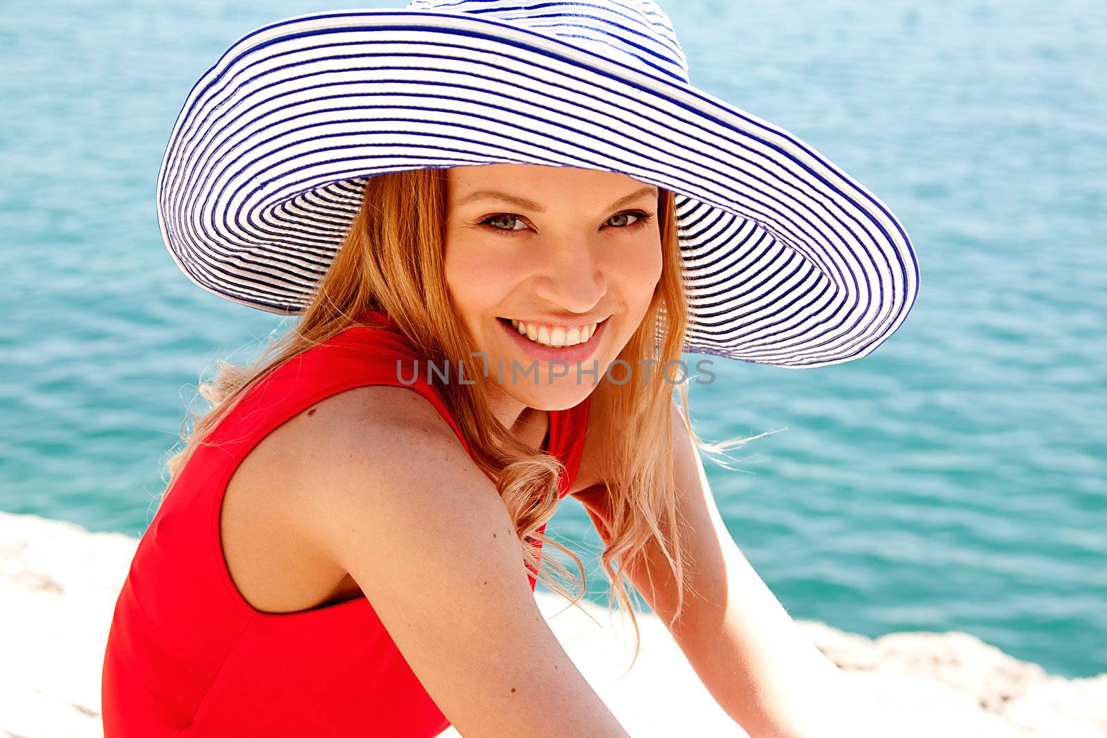 portrait of a beautiful young girl who rests on the coast