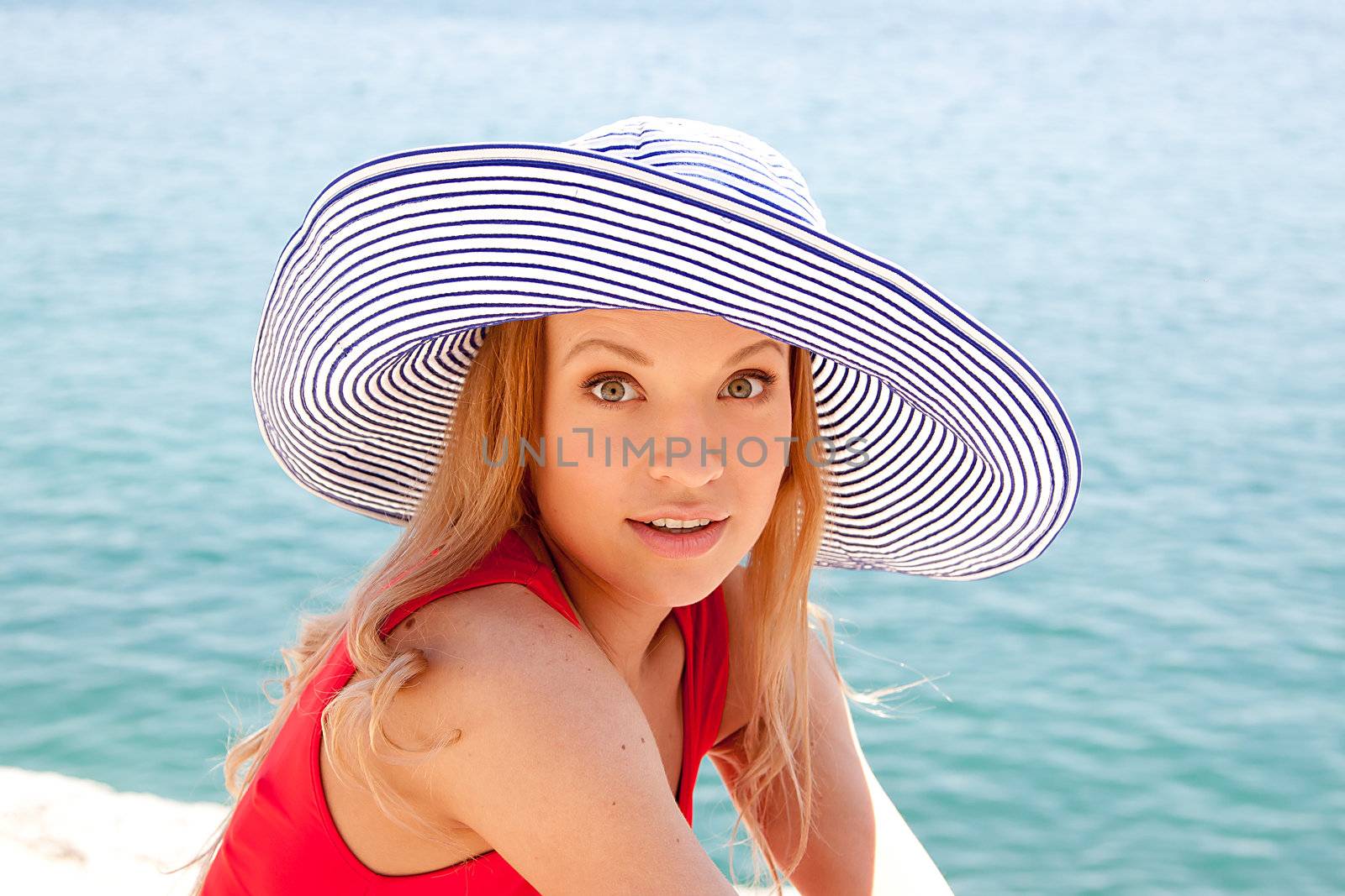 portrait of a beautiful young girl who rests on the coast