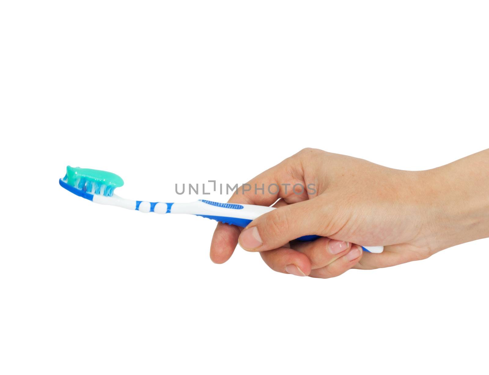 Toothbrush and toothpaste in a hand  by schankz