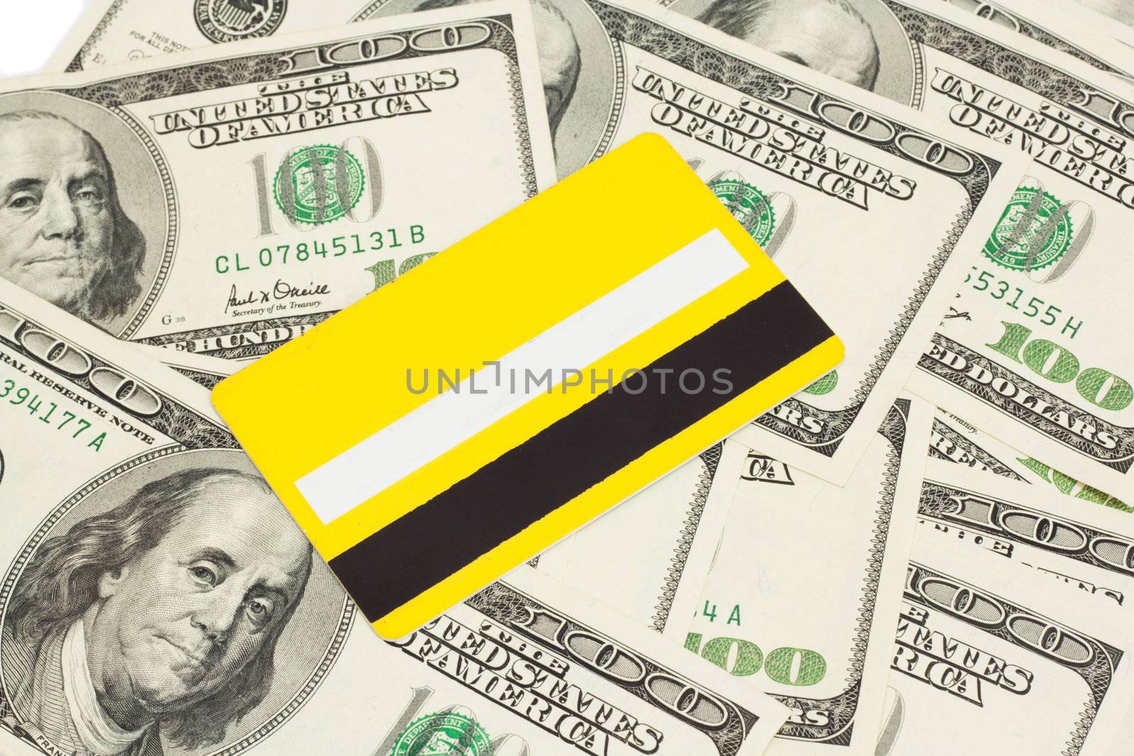 yellow plastic card against dollar by schankz