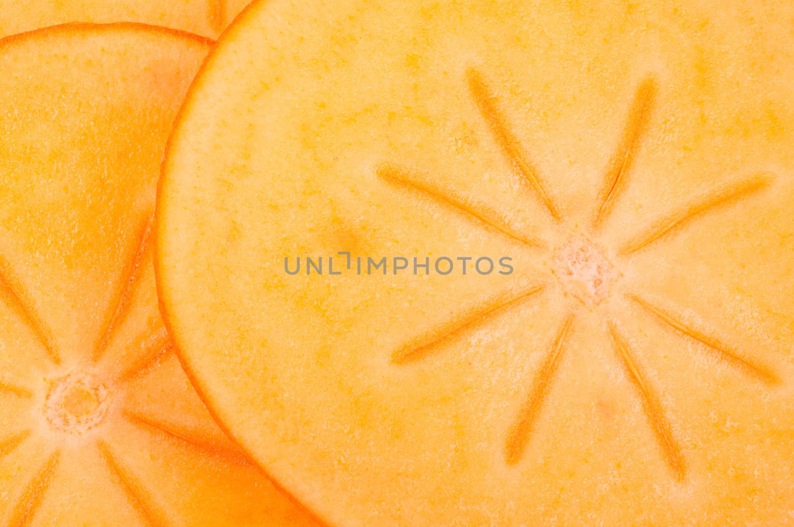 Cuted pieces persimmon  close up by Nanisimova