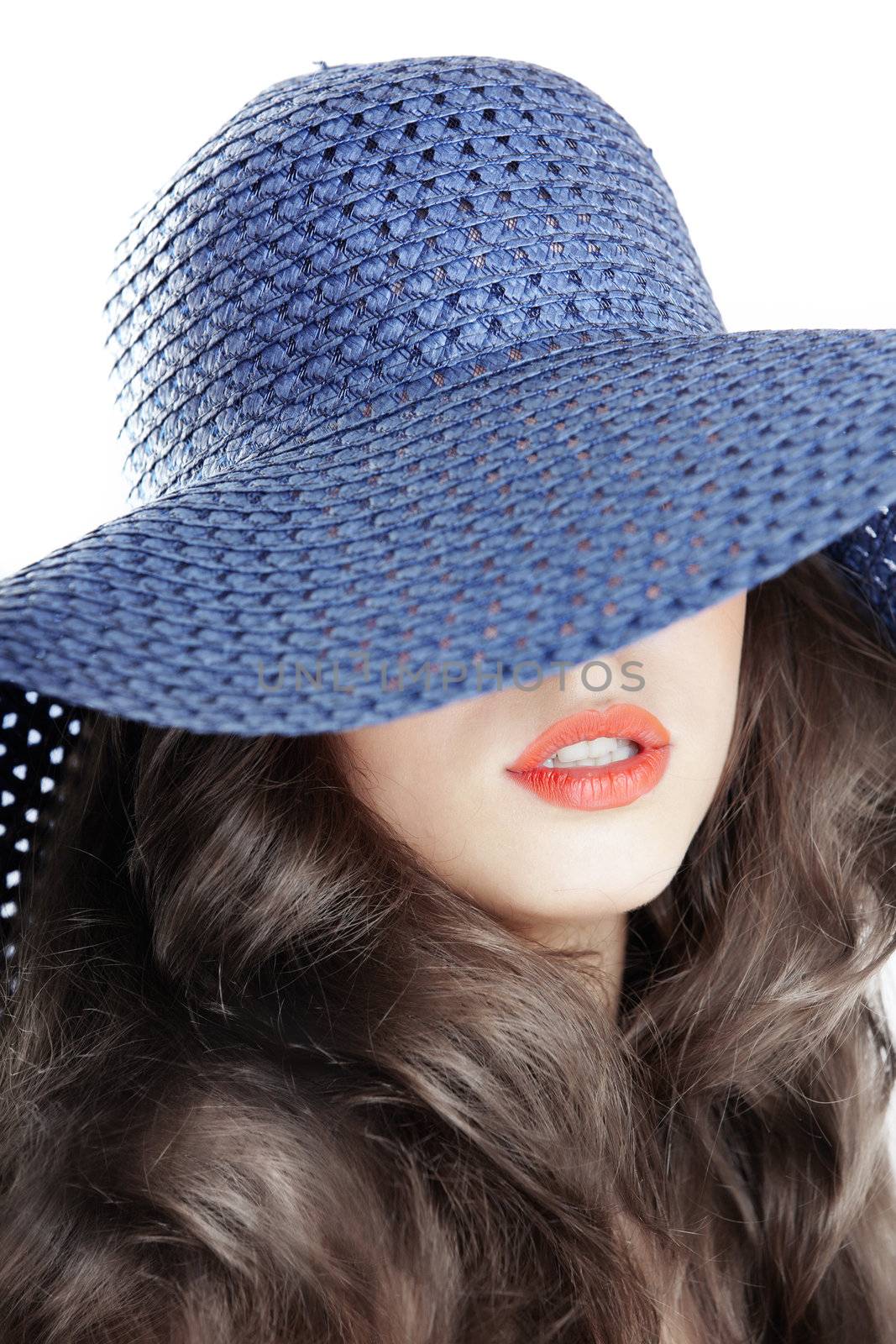 Smiling lady in blue summer hat. Studio photo