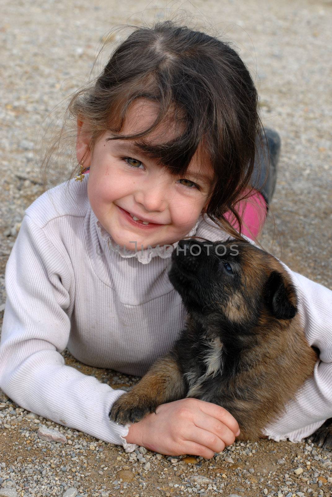 smiling little girl and her very young puppy