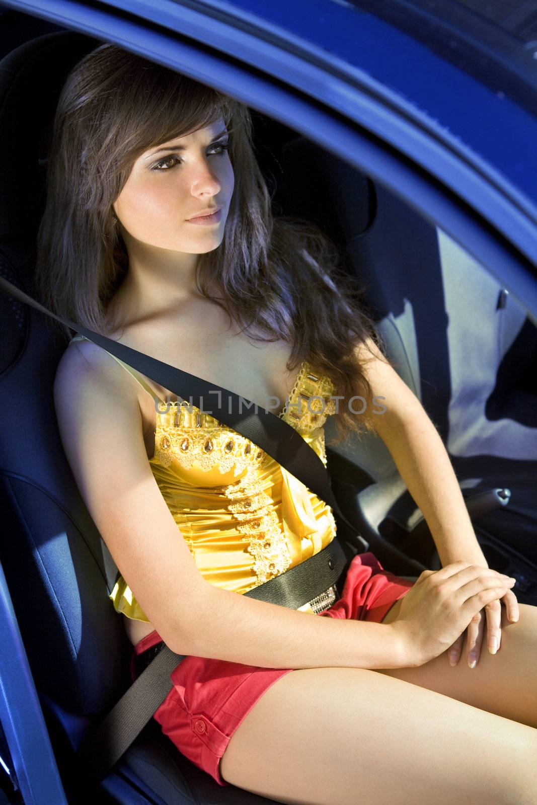 beautiful girl in car fastened by seat belt