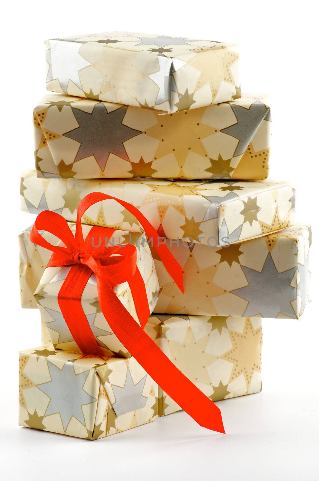 Stack of Gift Boxes and one with Red Satin Ribbon Bow isolated on white background