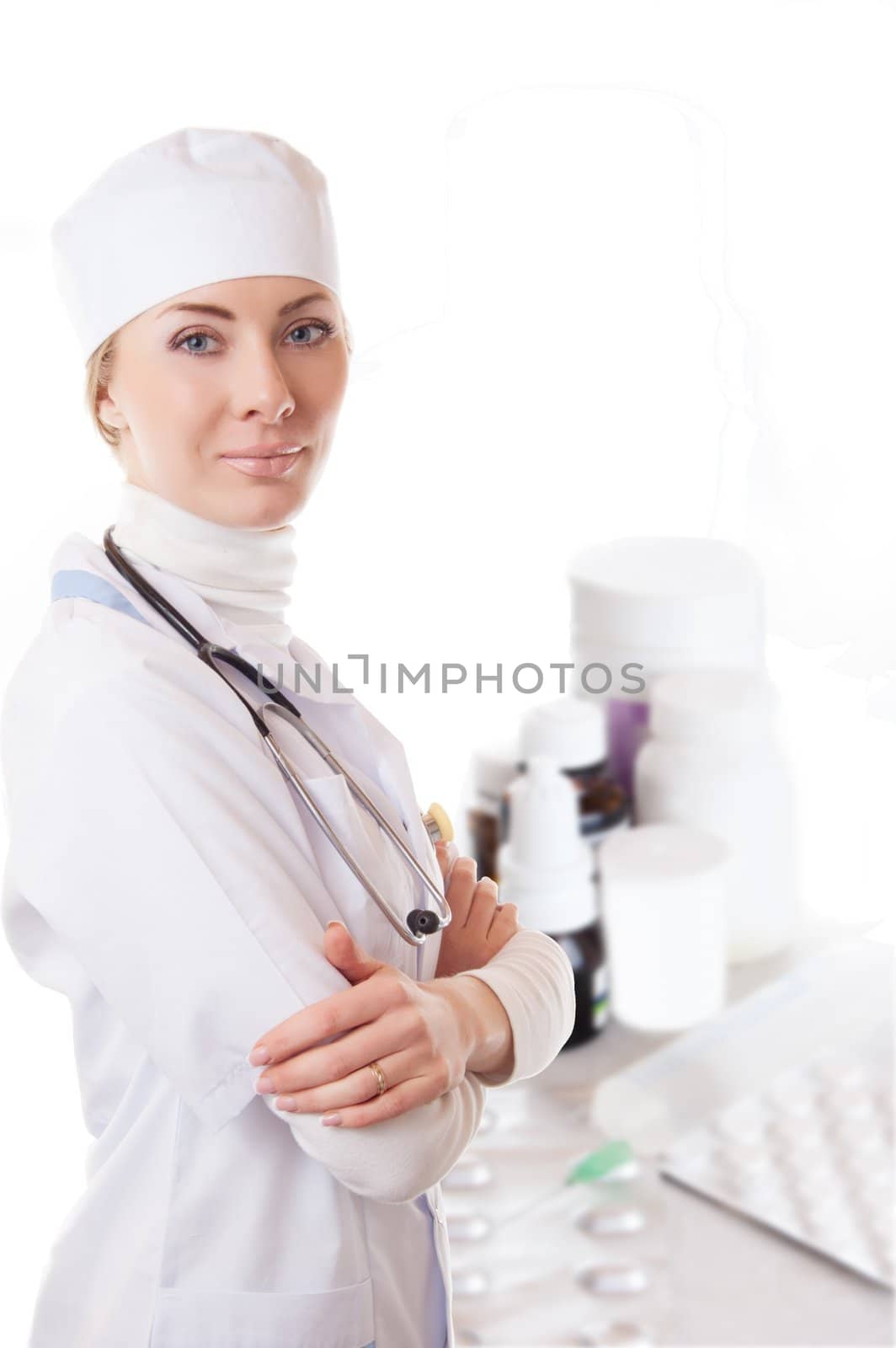 Medical doctor woman with stethoscope and some medicines isolated on white