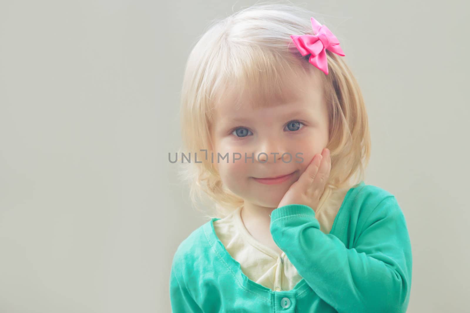 Lovely portrait of smiling baby girl with bow