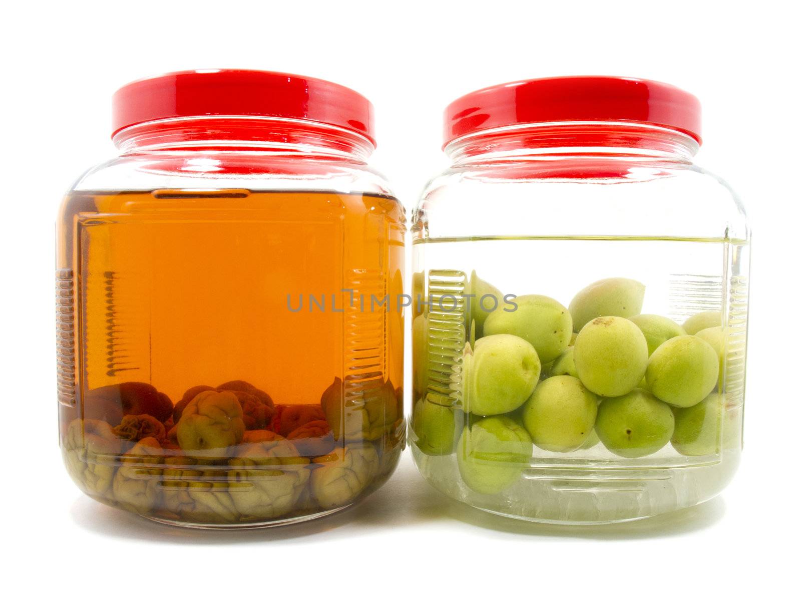 Before and after pickle Japanese plum liqueur in glass jar  by iampuay