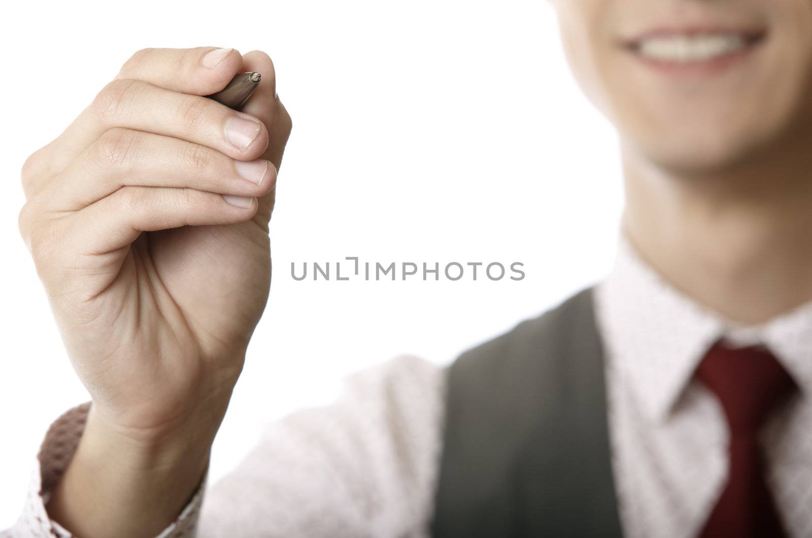 Young smiling businessman is writing on a virtual whiteboard. Focus is on the hand and pen