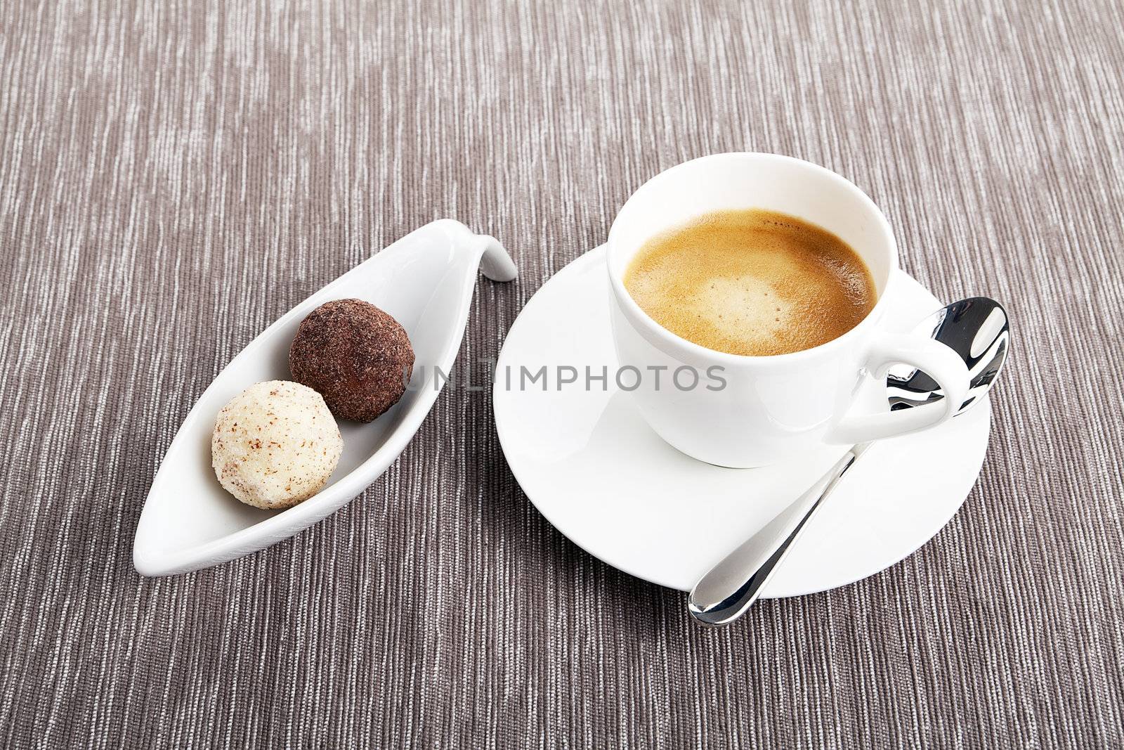 cup of coffee with mixed pralines 