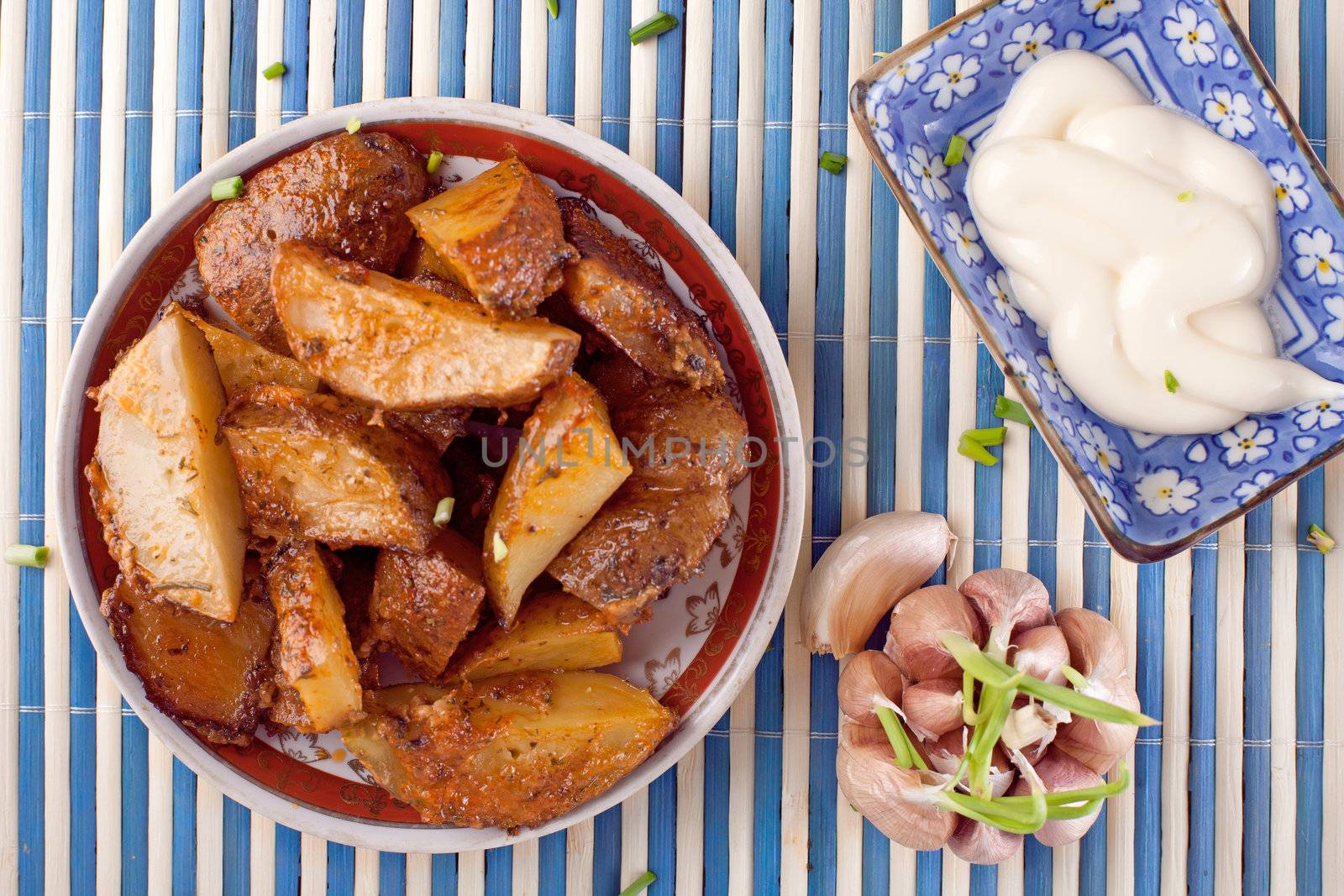 Baked potato with tomato sauce and mayonneise