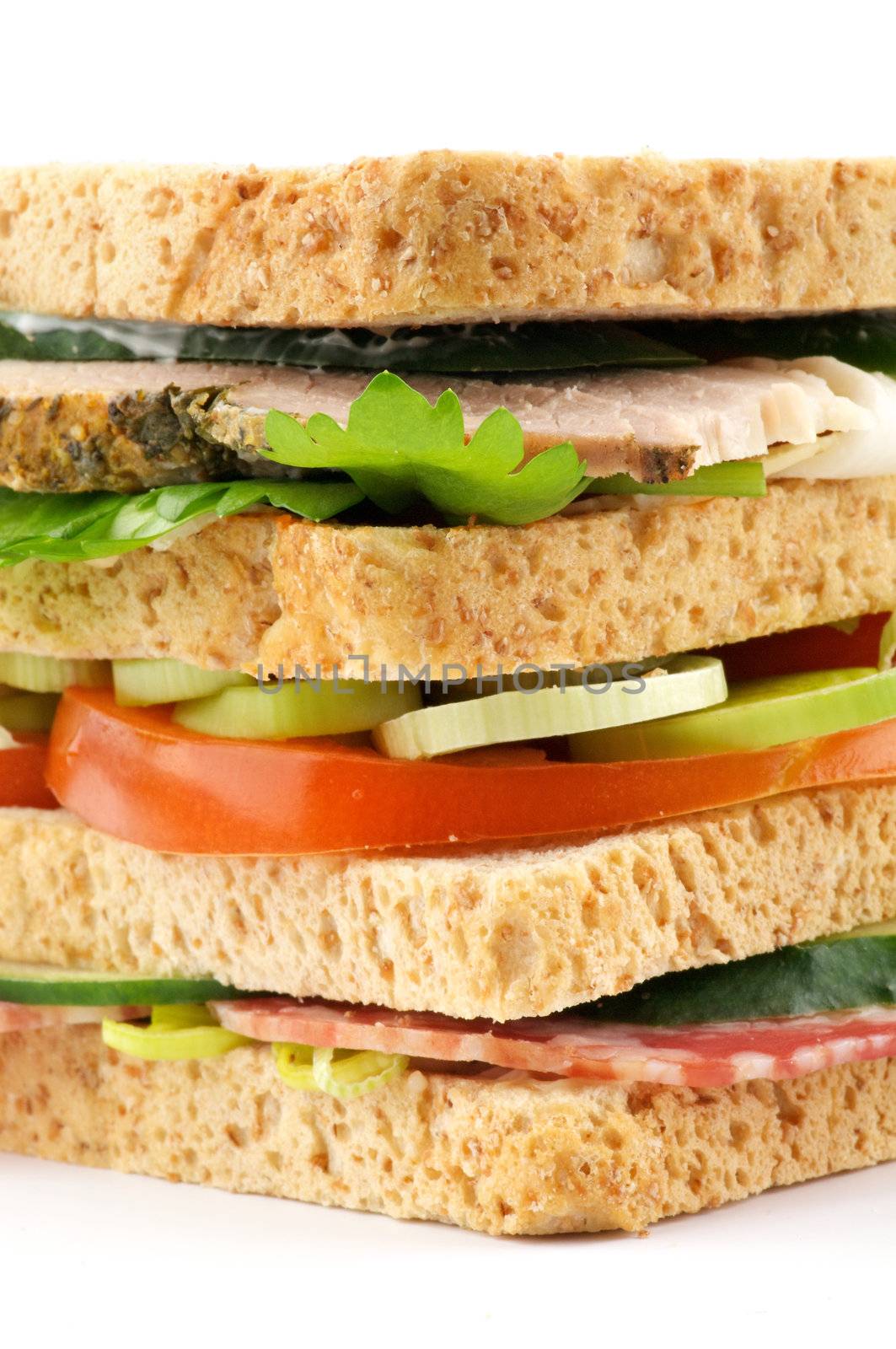 BLT Sandwich with ham, lettuce and tomato closeup on white background