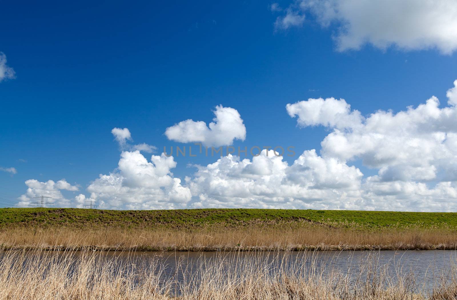 abstract landscape with pasture, river and blue sky with nice clouds