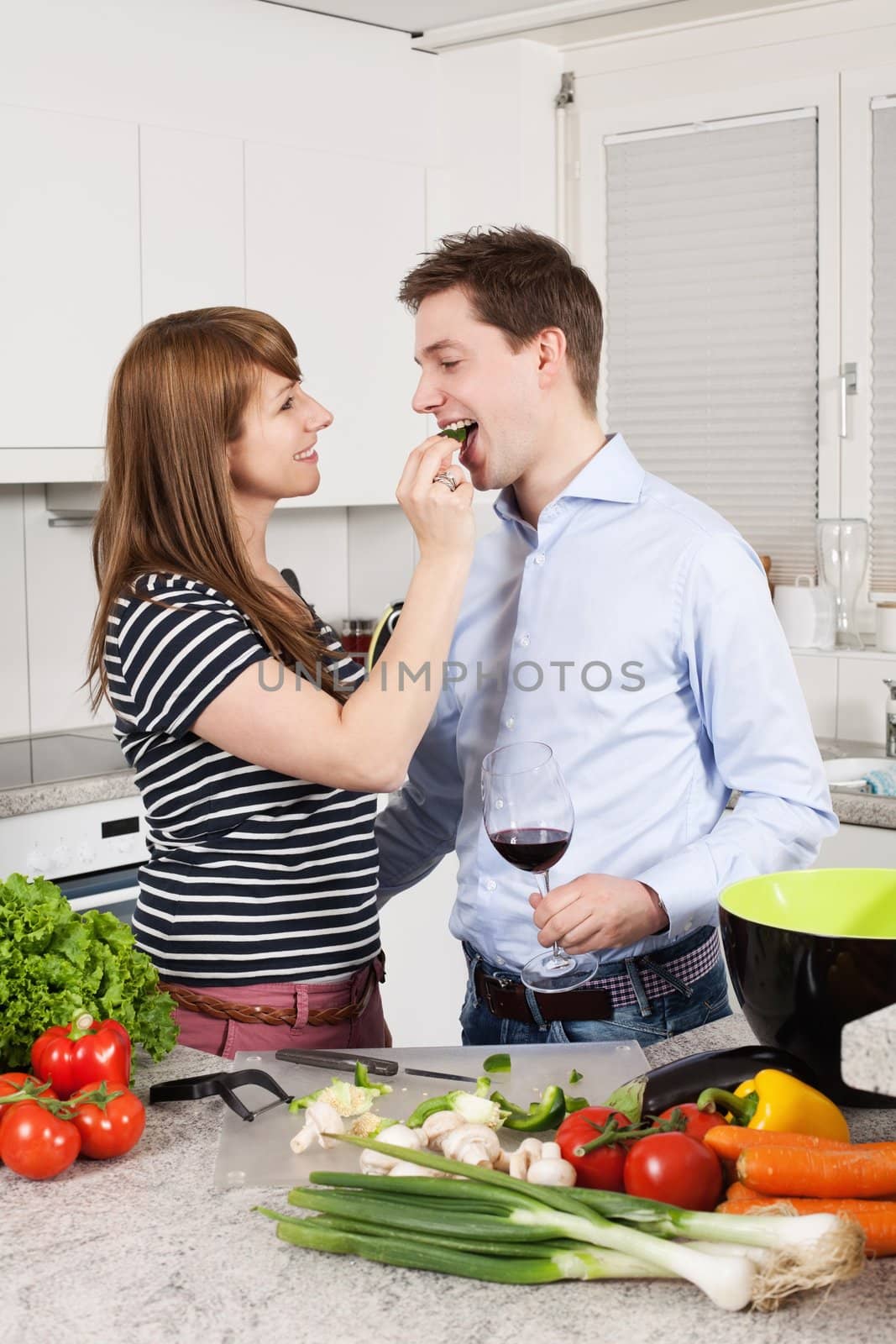 Couple in love preparing a meal by sumners