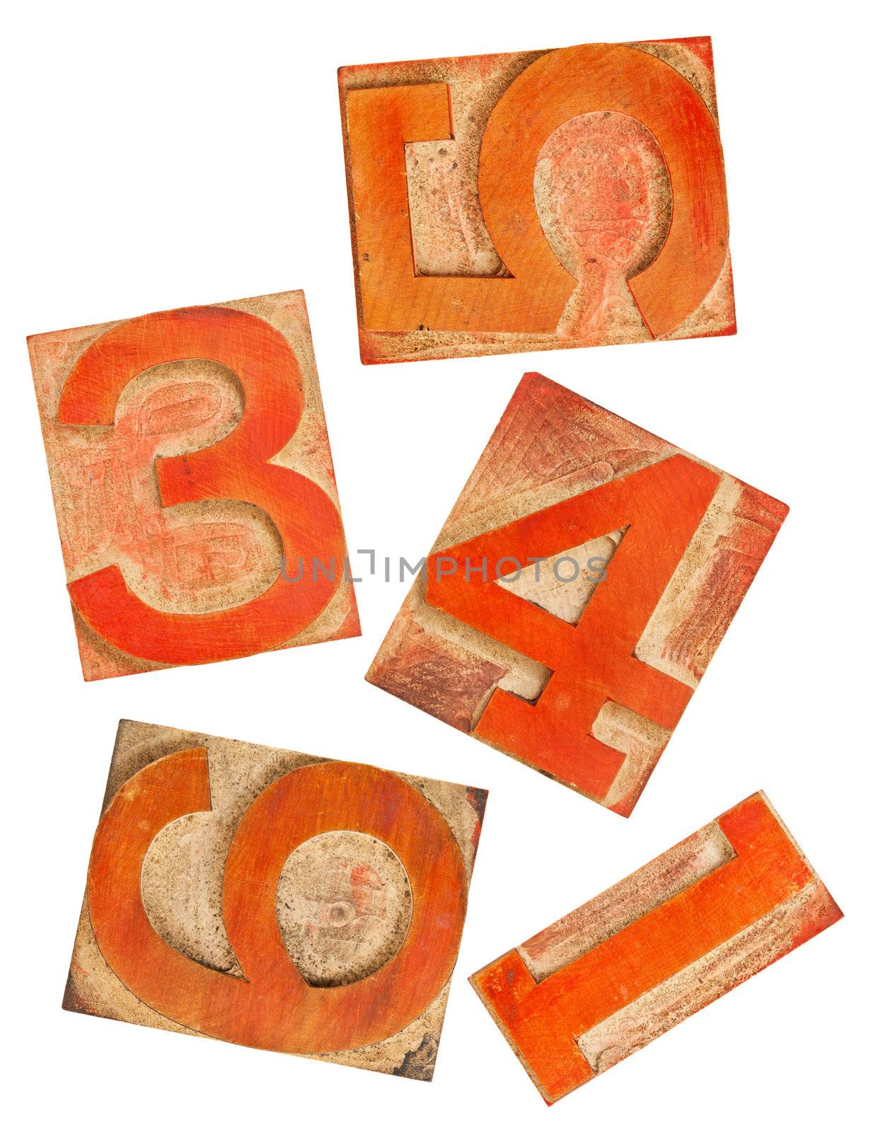 selected numbers in isolated  wooden letterpress printing blocks stained by red and orange ink