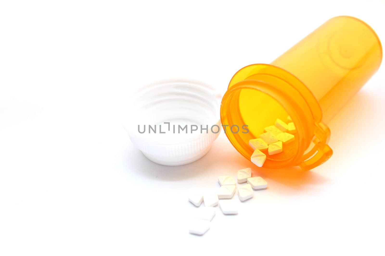 Prescription bottle with pills spilling out