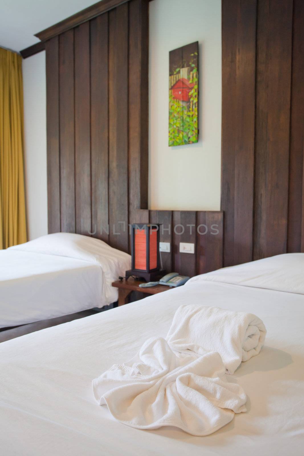 Hotel room in a tropical resort with bed and wooden flooring