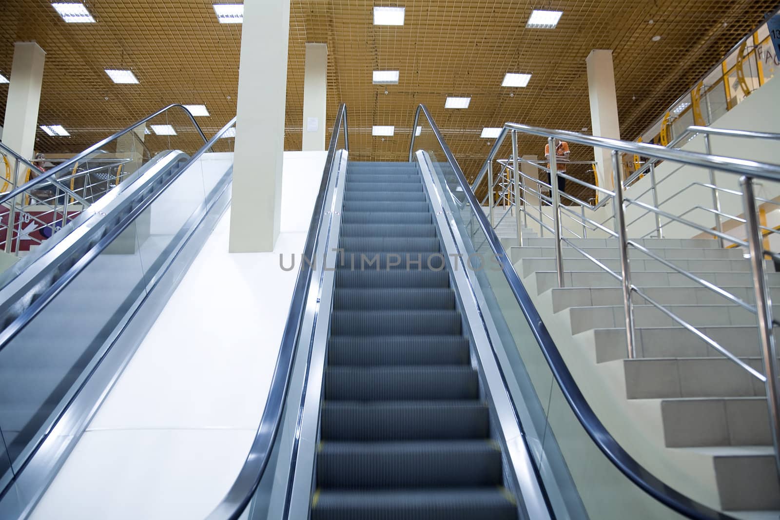 n:	moving escalator of modern large shopping centre or the airport by Serp