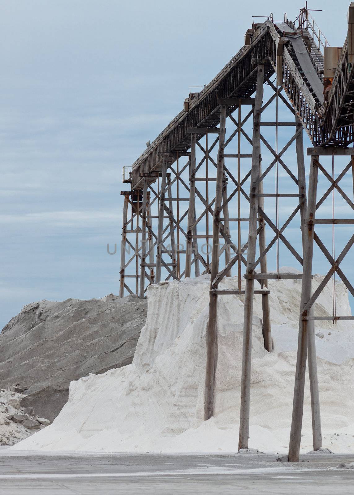 Pile of sea salt under conveyor of saline refinery by PiLens