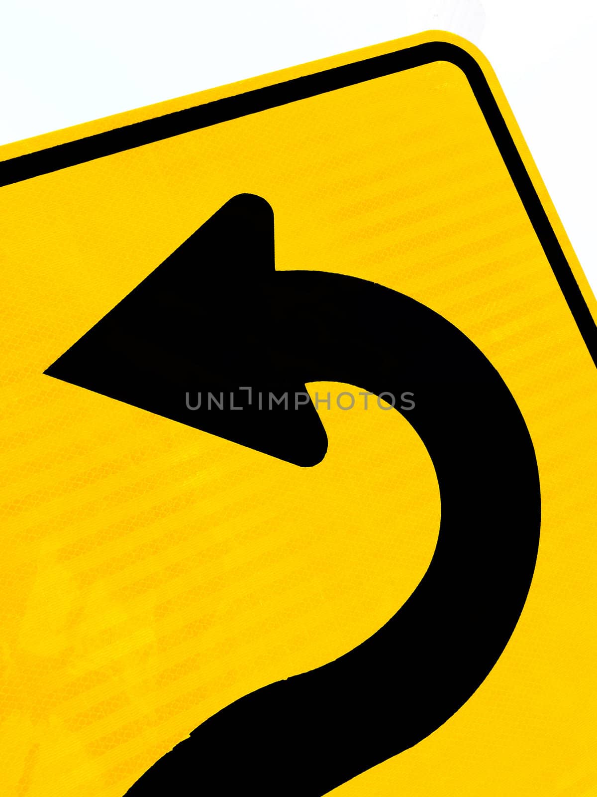 Sharply curving arrow on road sign pointing left in a concept of turning around, correction and betterment isolated on white