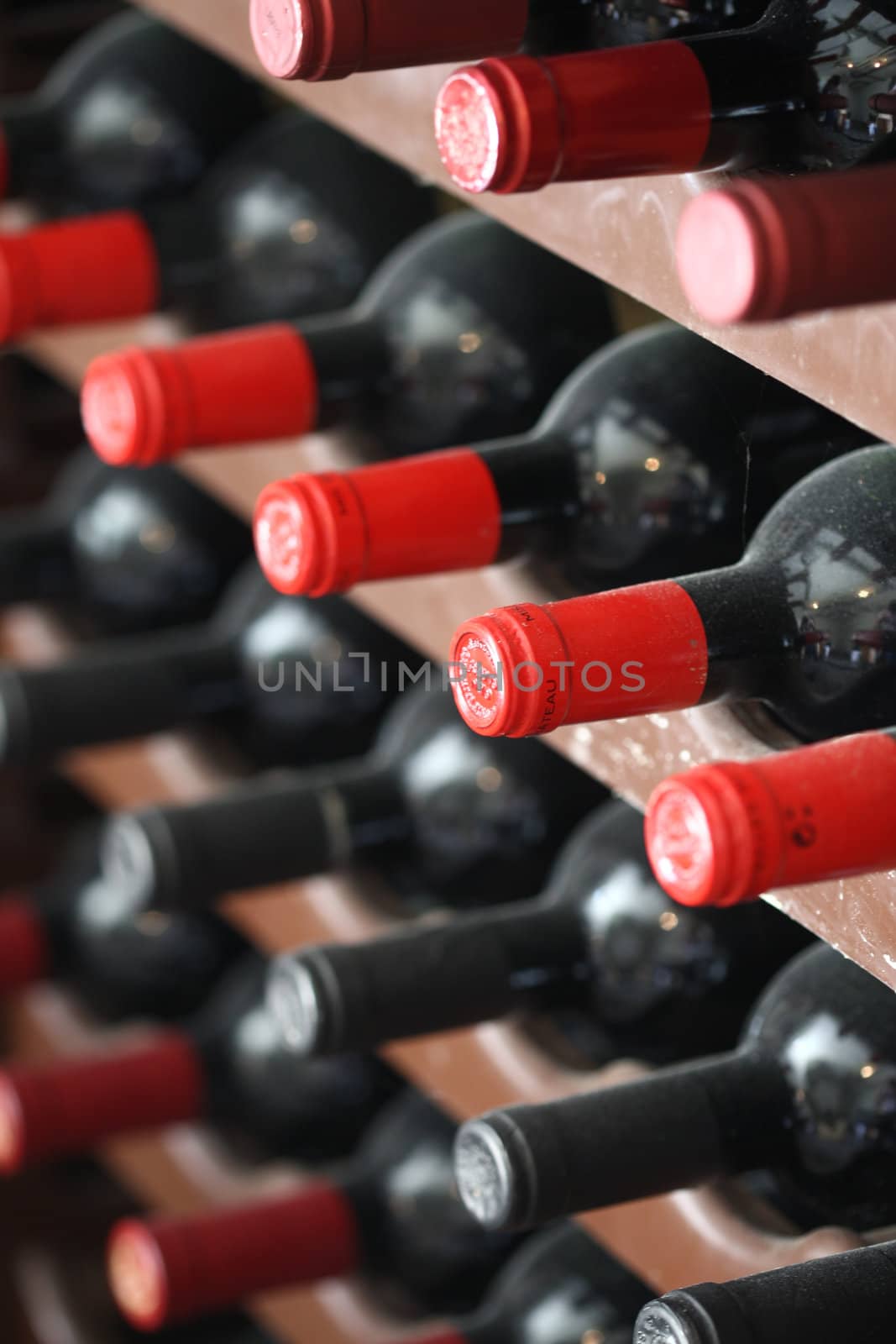 Bordeaux wine bottles with red caps