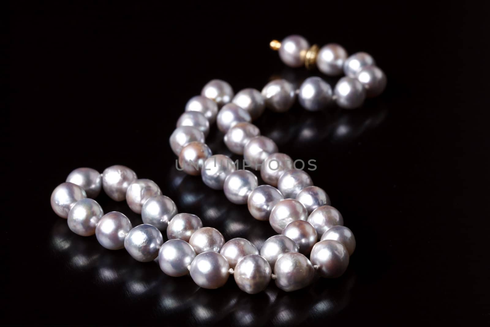 grey pearls on black background