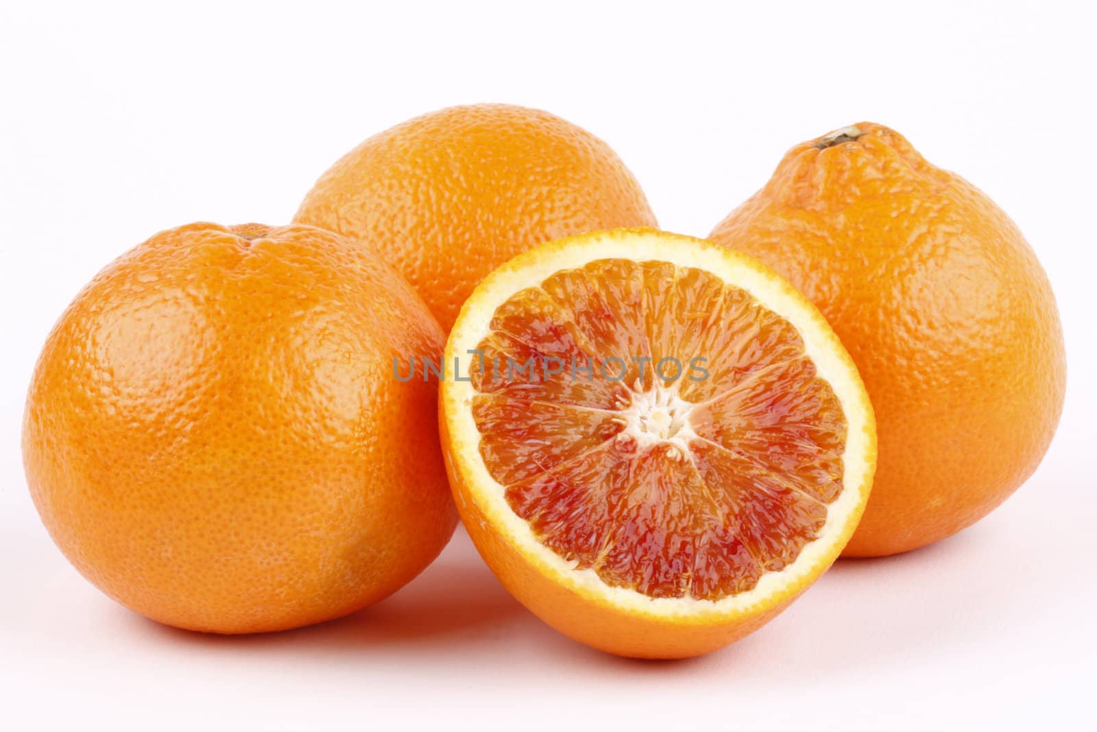 blood oranges on white background