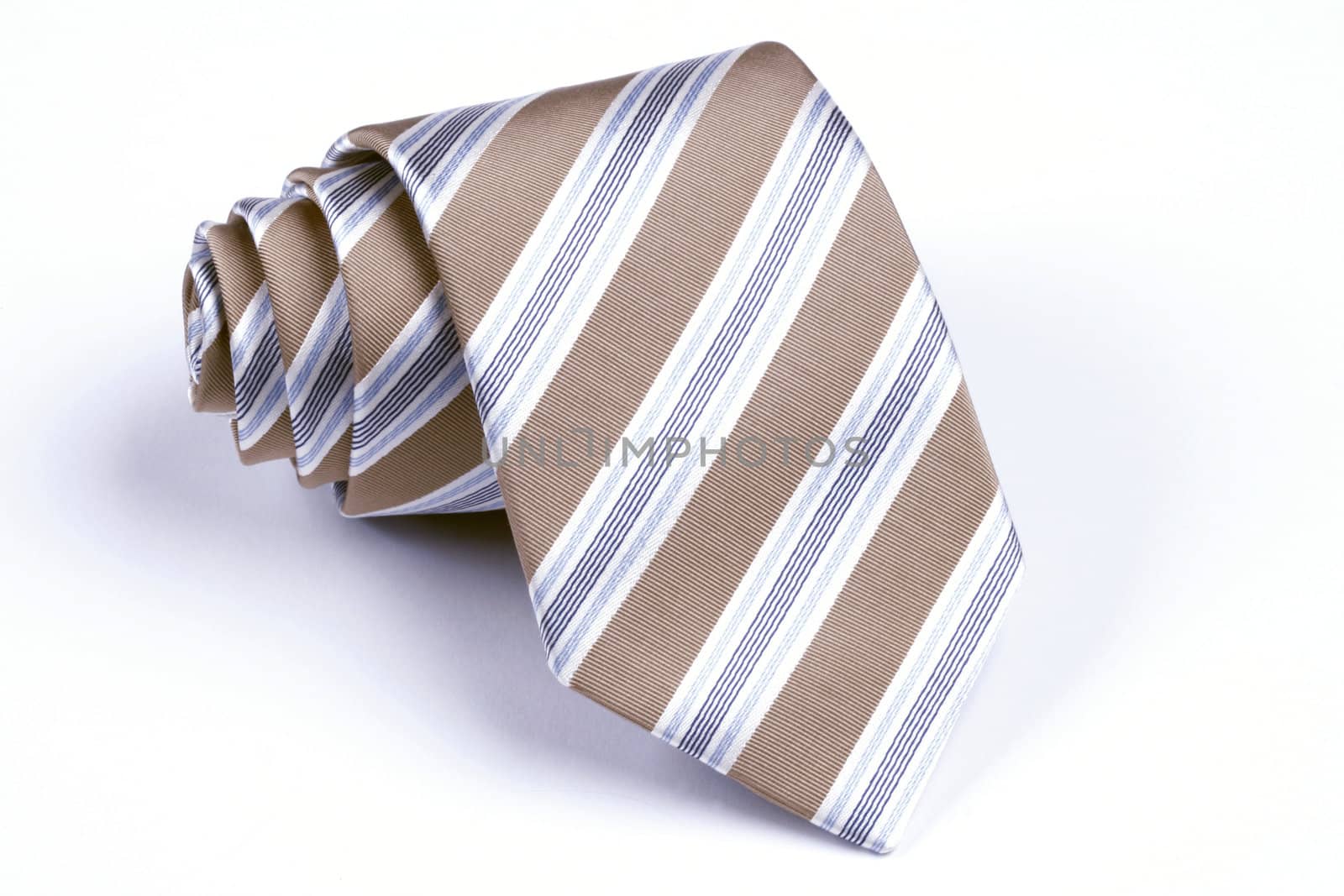 beige, blue and white striped necktie rolled up on white background