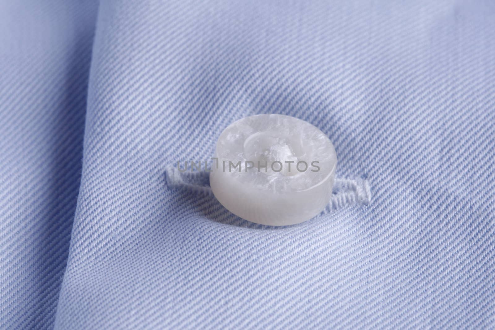 Textile background. close-up of a button and buttonhole on a business shirt