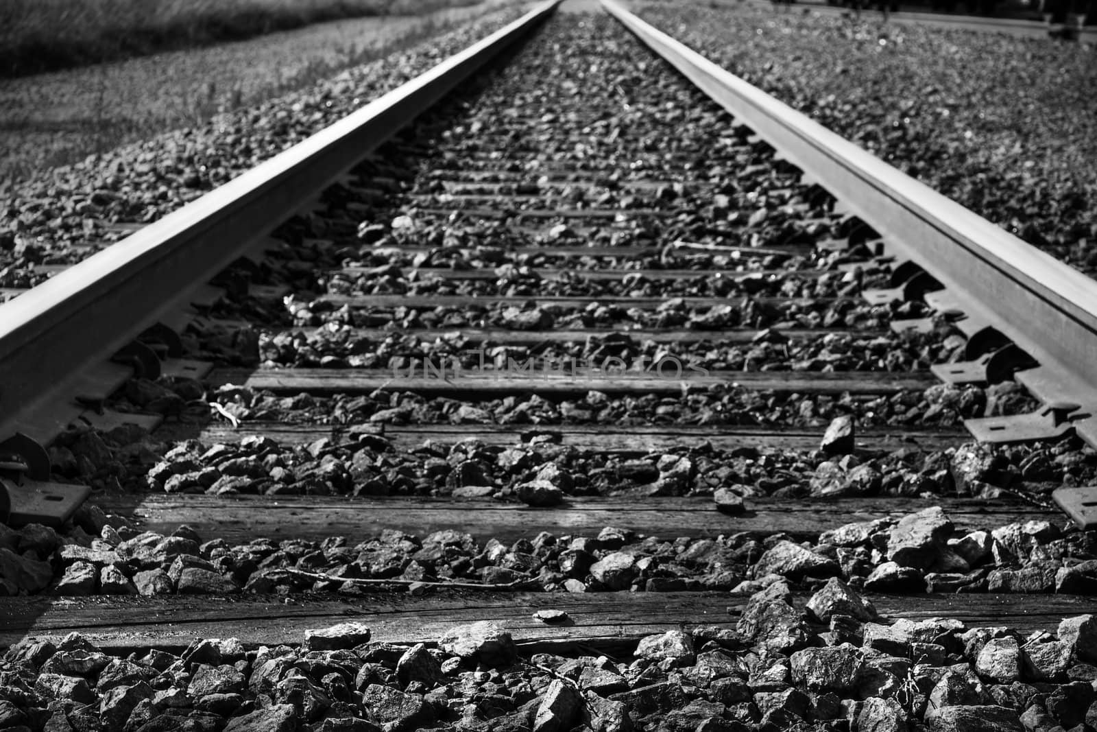 Dramatic black and white rendering of train tracks with diminishing perspective, great background.
