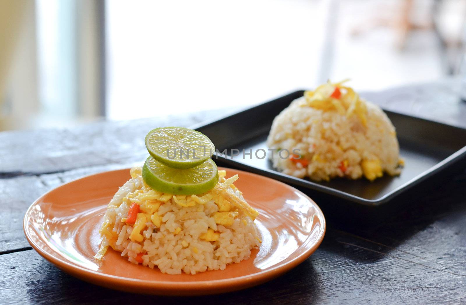 two dish of  fried rice on wood table 