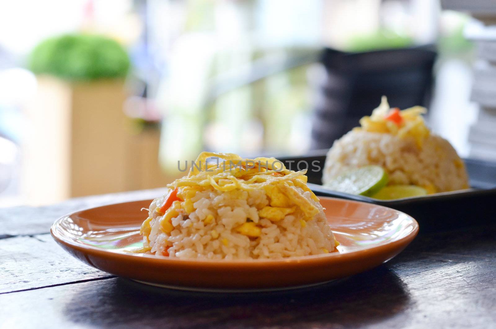 two dish of delicious  fried rice on wood table 