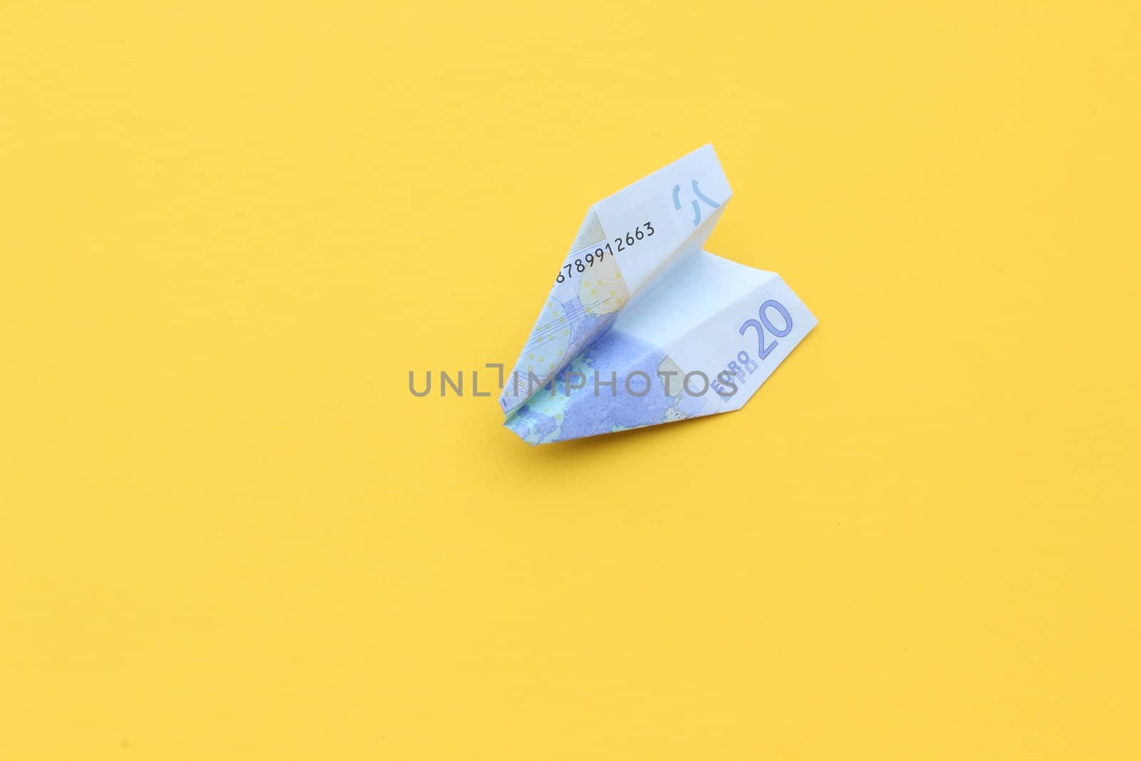 nice conceptual image of money airplane on yellow background