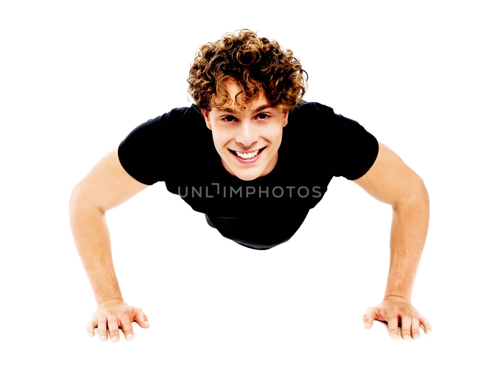 Healthy young guy doing push-ups exercise against white background