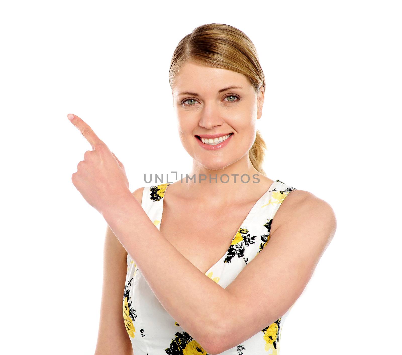 Happy young woman pointing copyspace by stockyimages