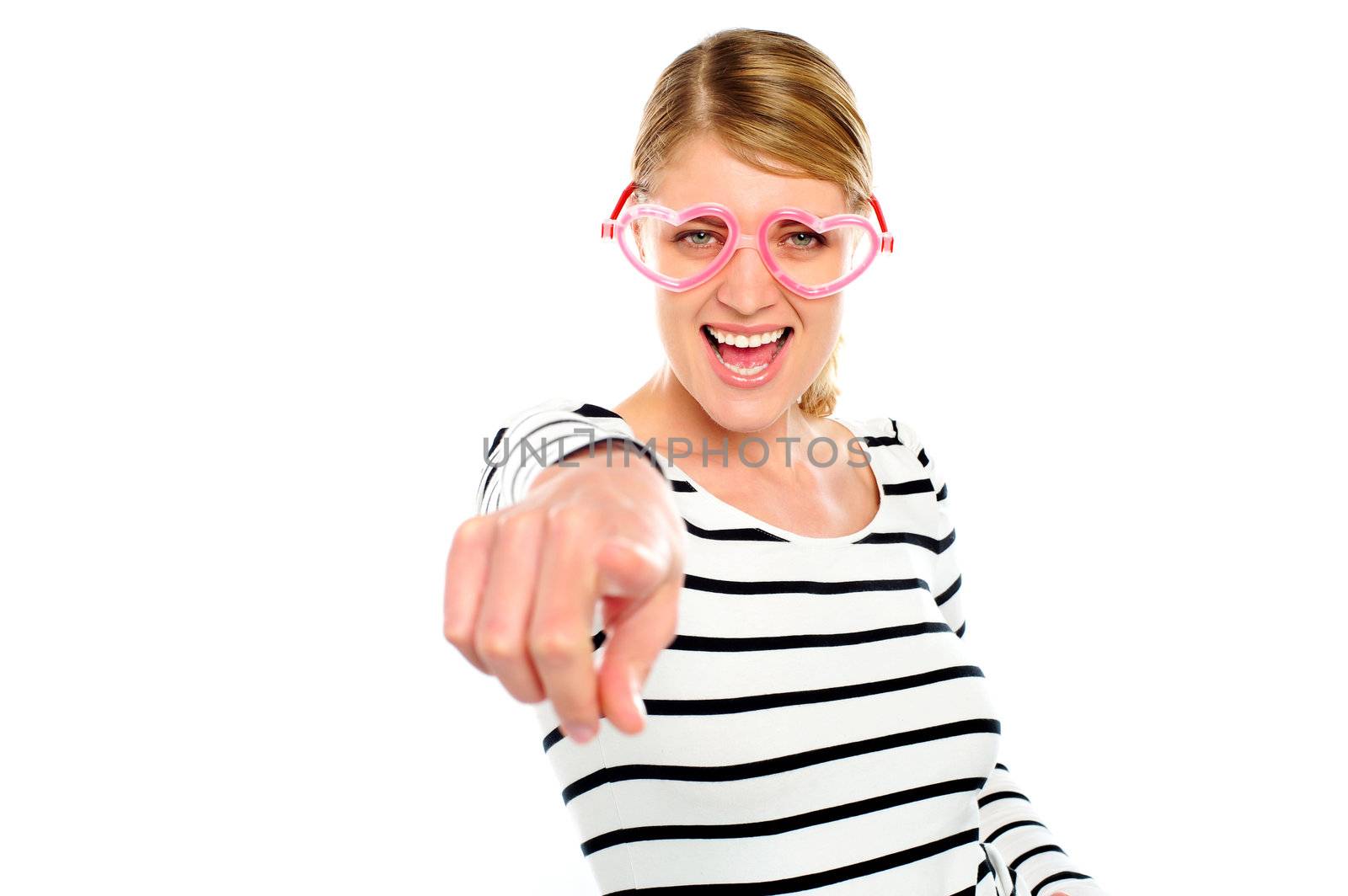 Excited woman pointing at you by stockyimages