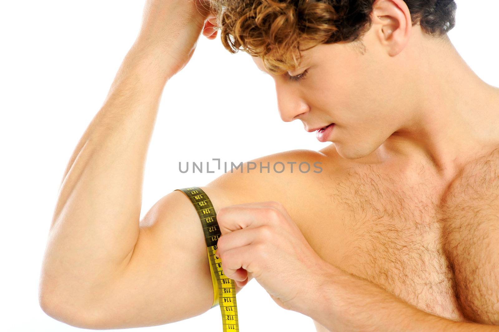 Handsome guy measuring his biceps with tape, closeup