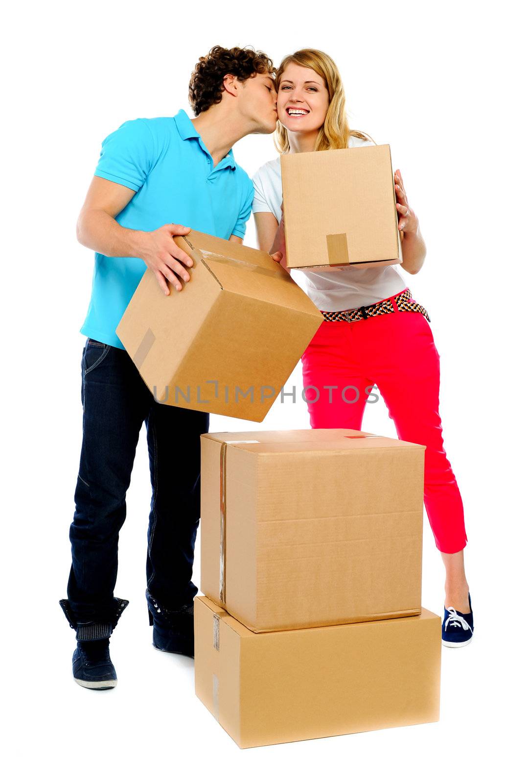 Young couple gently holding cartons by stockyimages