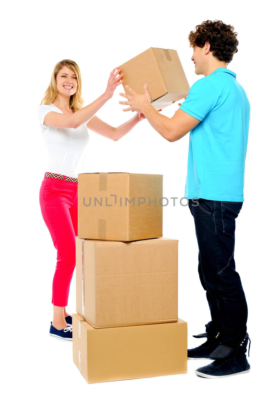 Couple carrying empty cartons by stockyimages
