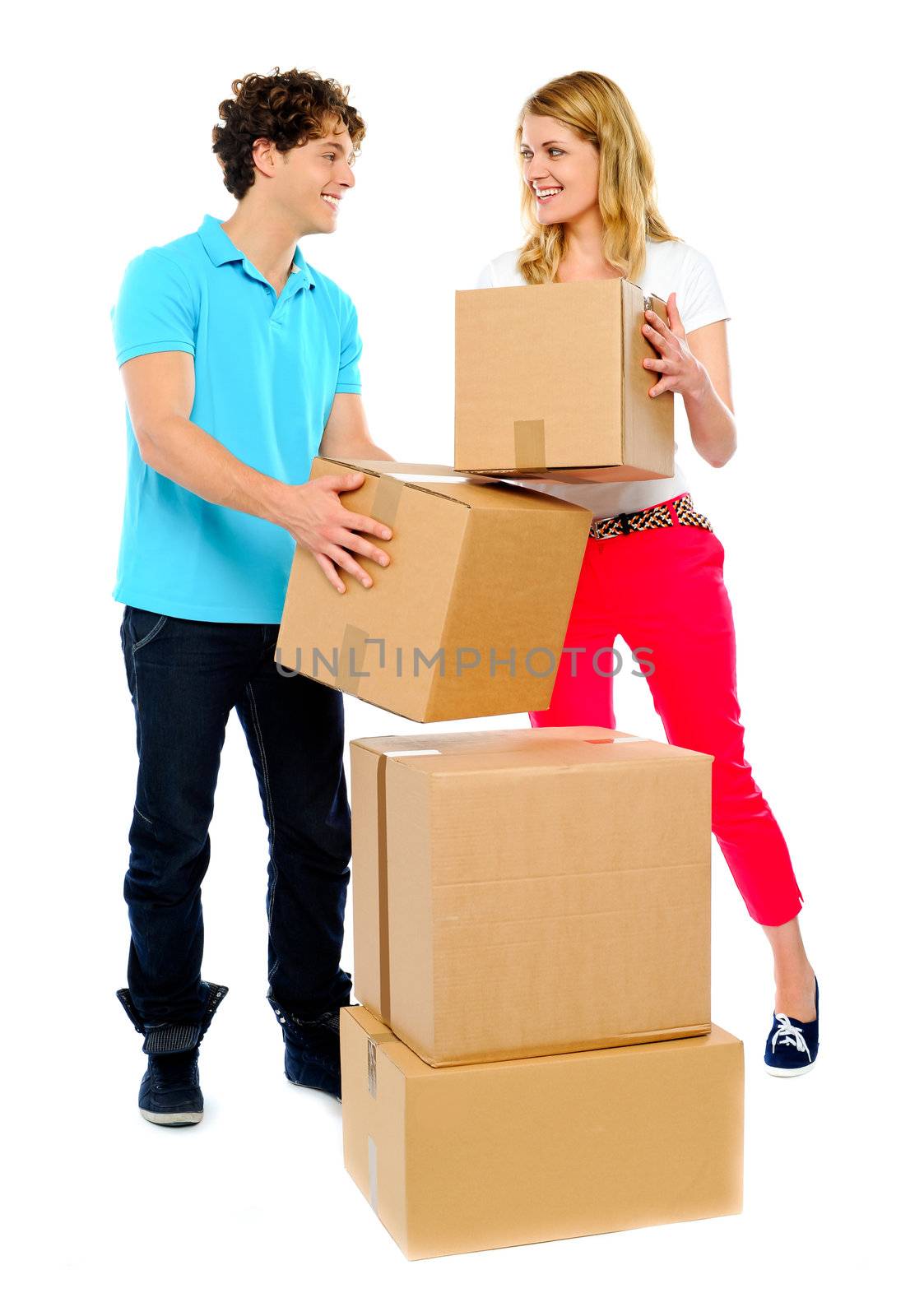 Couple carrying cardboard boxes by stockyimages