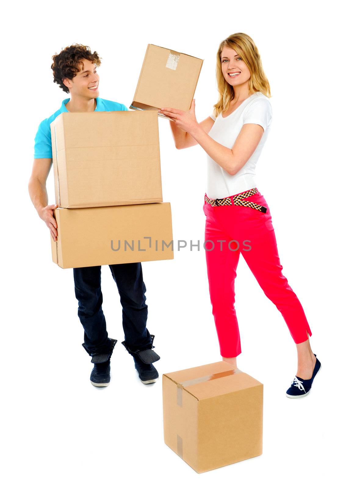 Girl passing cardboard boxes to man while he holds pile of them. All on white background