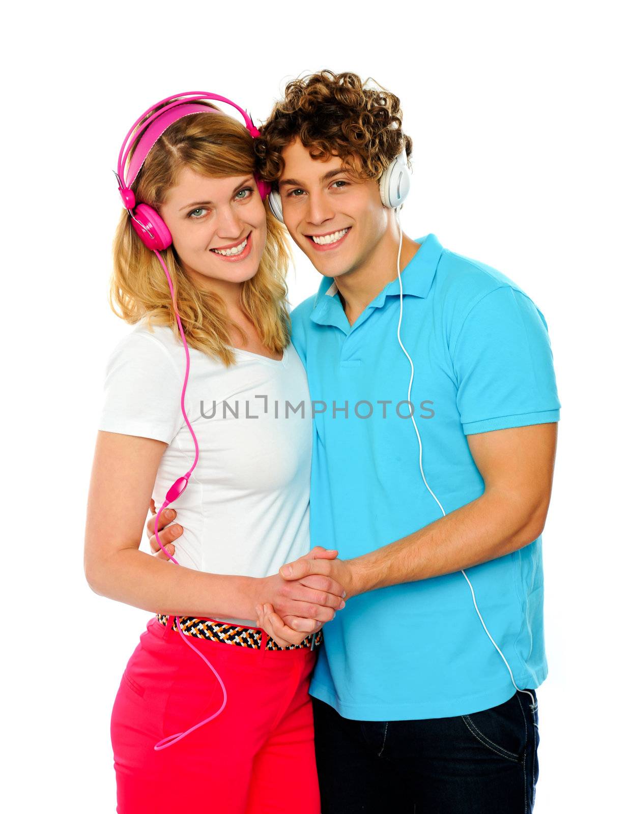 Love couple holding hands and listening music against white background