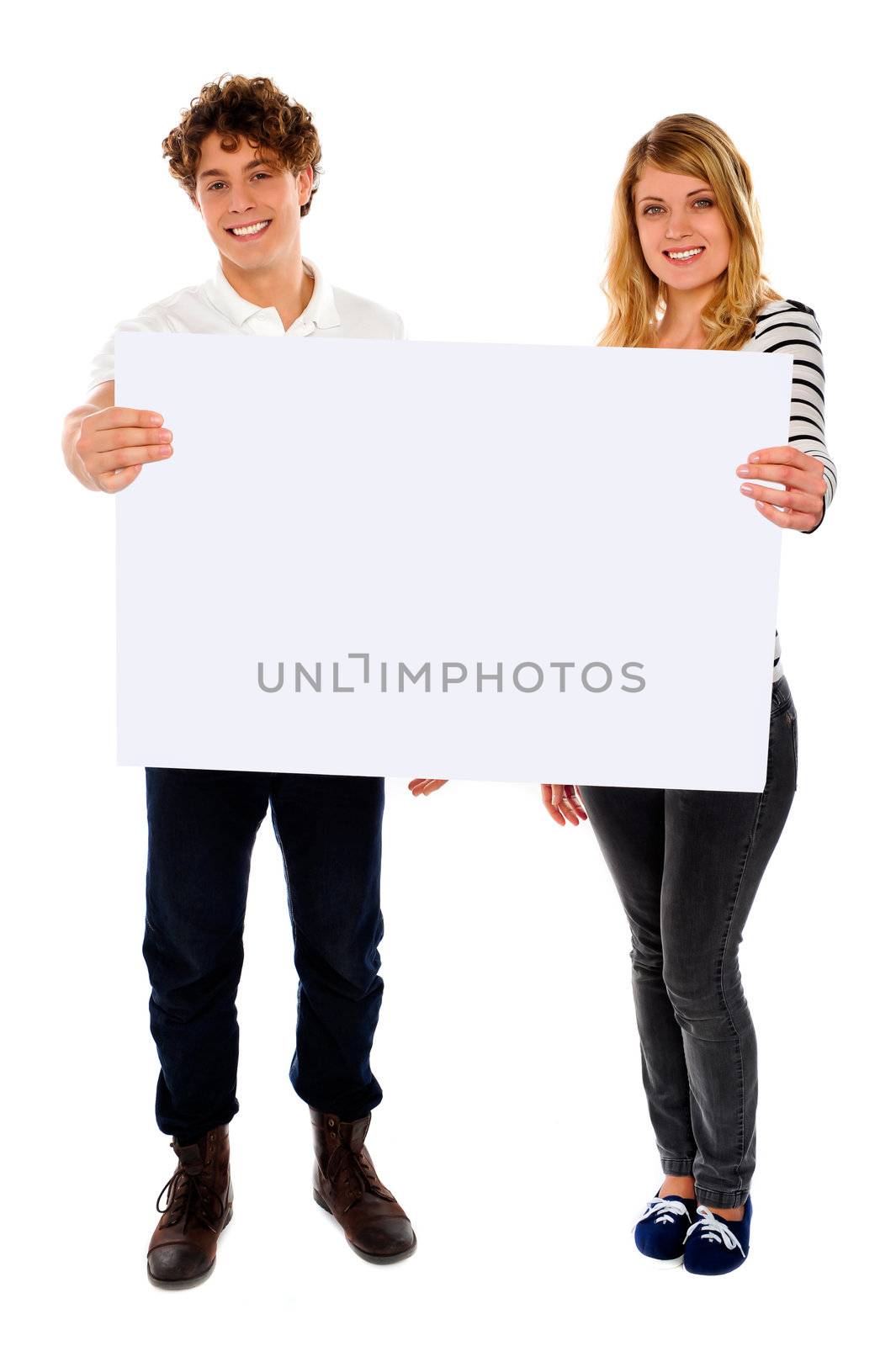 Adorable young couple promoting blank banner ad by stockyimages