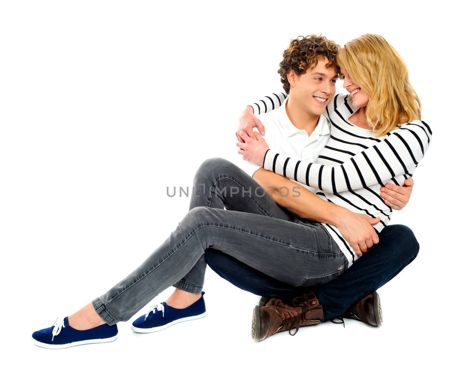 Couple looking at each other. Girl sitting on lap of her partner. Deeply in love