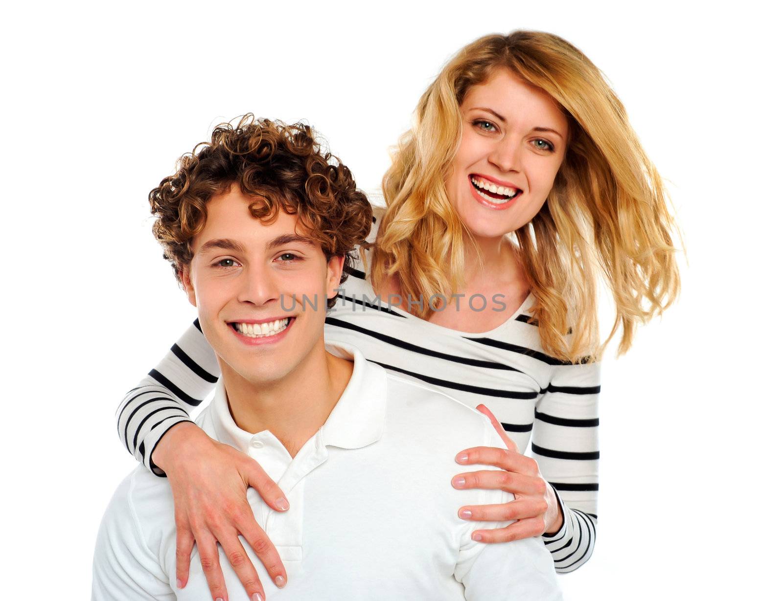 Portrait of happy woman hugging man from behind