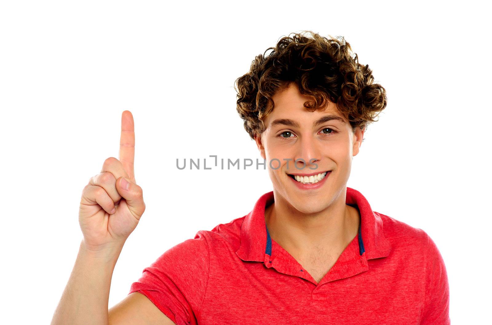 Casual guy indicating upwards over white background